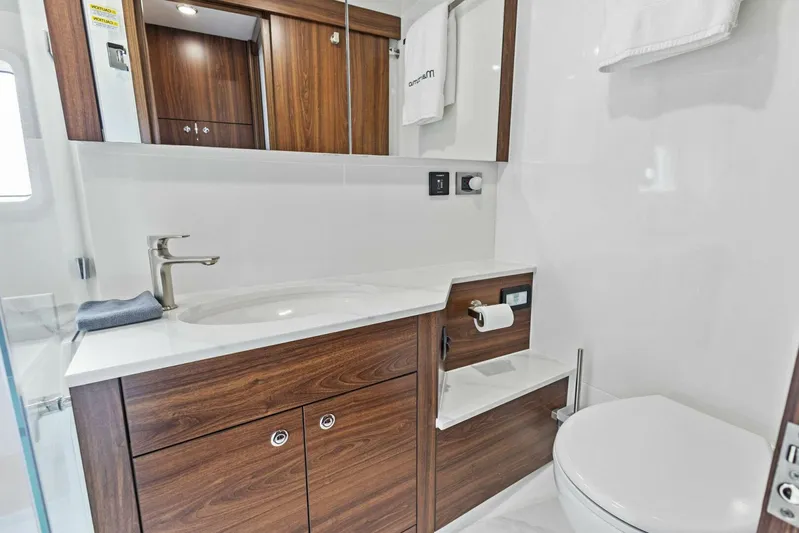 Barbara Sue III Yacht Photos Pics Luxurious bathroom in 2025 Maritimo M55 yacht with wood accents and modern fixtures.