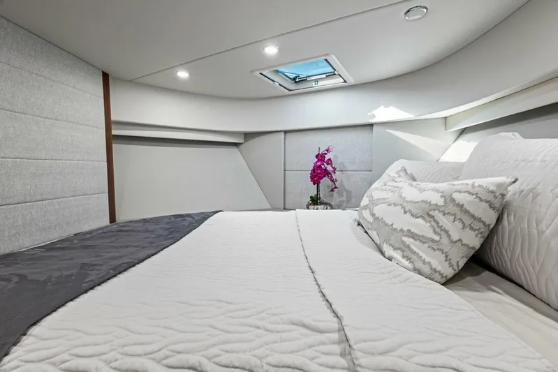 Barbara Sue III Yacht Photos Pics Luxurious bedroom interior of 2025 Maritimo M55 yacht with elegant bedding and skylight.