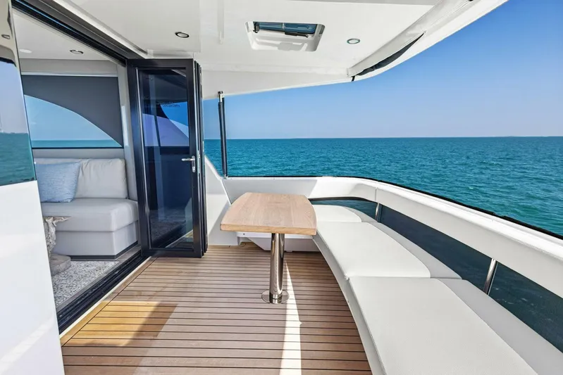Barbara Sue III Yacht Photos Pics 2025 Maritimo M55 yacht deck with seating, table, and ocean view.