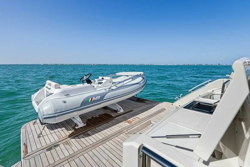 Barbara Sue III Yacht Photos Pics 2025 Maritimo M55 yacht with tender on deck, ocean view.