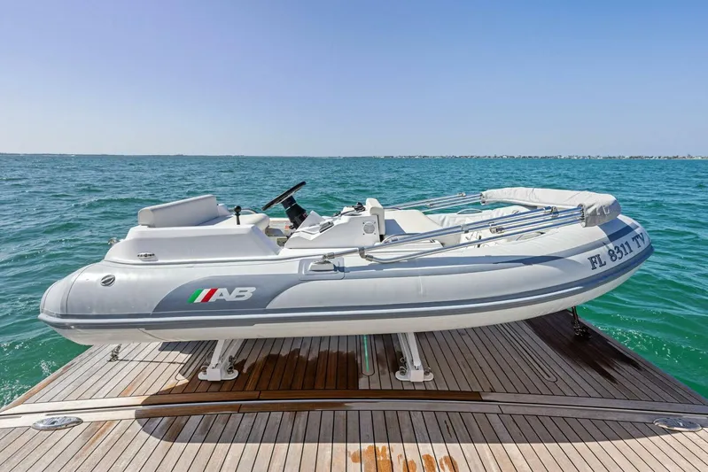 Barbara Sue III Yacht Photos Pics 2025 Maritimo M55 yacht with inflatable tender on deck, floating on calm blue sea.