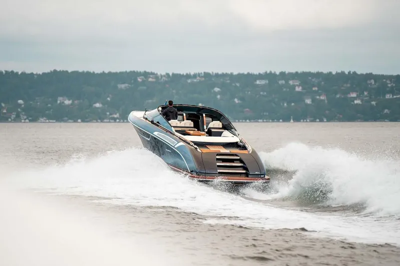  Yacht Photos Pics 2021 Riva Rivamare 38 luxury yacht cruising on a scenic lake.