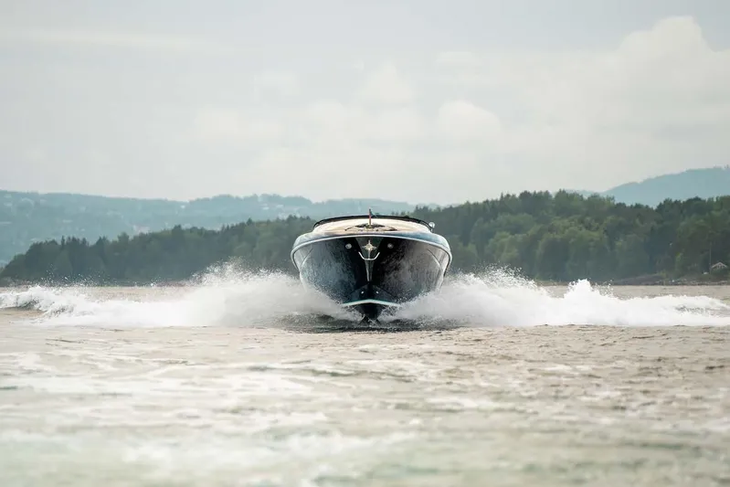  Yacht Photos Pics 2021 Riva Rivamare 38 cruising on water with scenic forest backdrop.