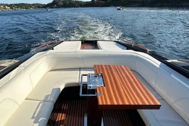  Yacht Photos Pics Luxurious 2021 Riva Rivamare 38 yacht interior with elegant seating and wooden table on open water.