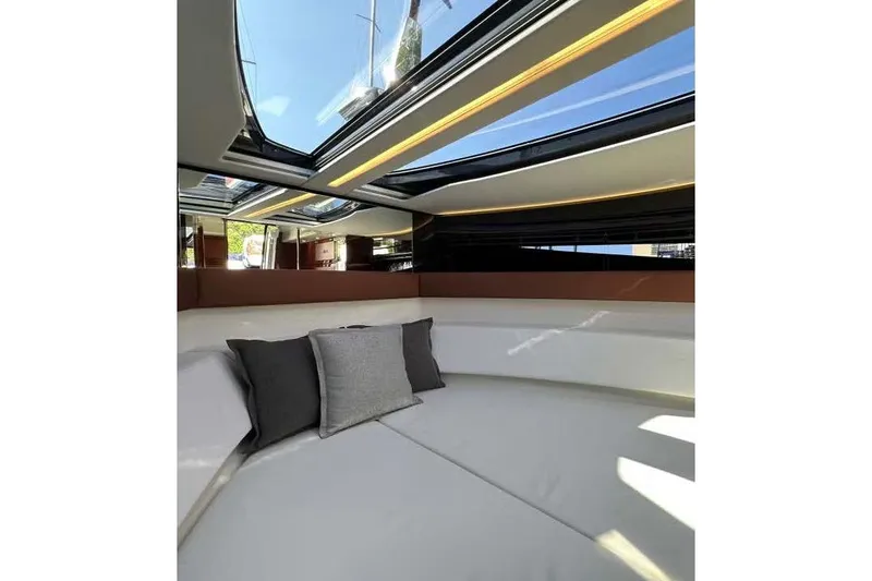  Yacht Photos Pics Luxurious interior of 2021 Riva Rivamare 38 yacht with skylight and cushions.