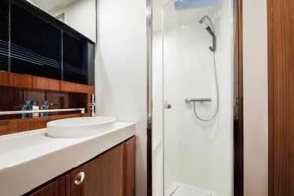 Yacht Photos Pics 2021 Riva Rivamare 38 yacht bathroom with modern shower and sleek wooden cabinetry.