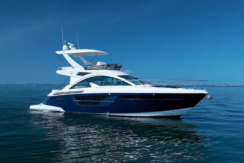 Stepping Stone V Yacht Photos Pics 2018 Cruisers Yachts 54 Fly on calm blue water under clear sky.