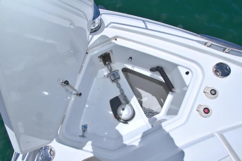 Stepping Stone V Yacht Photos Pics Anchor compartment of 2018 Cruisers Yachts 54 Fly, featuring chain and controls.