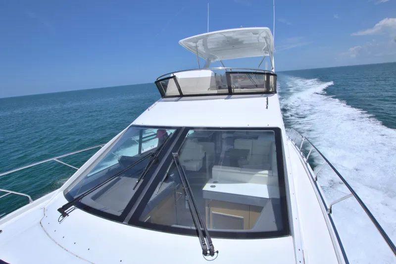 Stepping Stone V Yacht Photos Pics 2018 Cruisers Yachts 54 Fly cruising on open water under clear blue skies.
