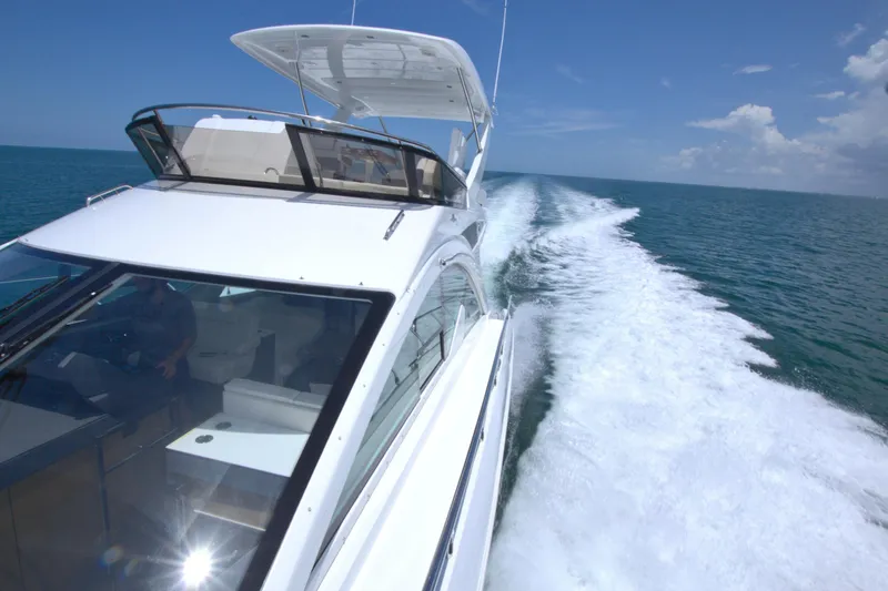Stepping Stone V Yacht Photos Pics 2018 Cruisers Yachts 54 Fly cruising on open water under clear blue skies.