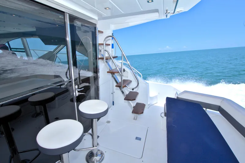 Stepping Stone V Yacht Photos Pics Luxurious 2018 Cruisers Yachts 54 Fly with ocean view, sleek seating, and elegant staircase.