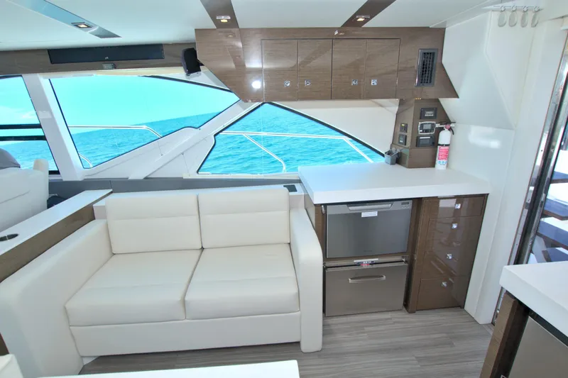 Stepping Stone V Yacht Photos Pics Luxurious interior of 2018 Cruisers Yachts 54 Fly with modern kitchen and ocean view.