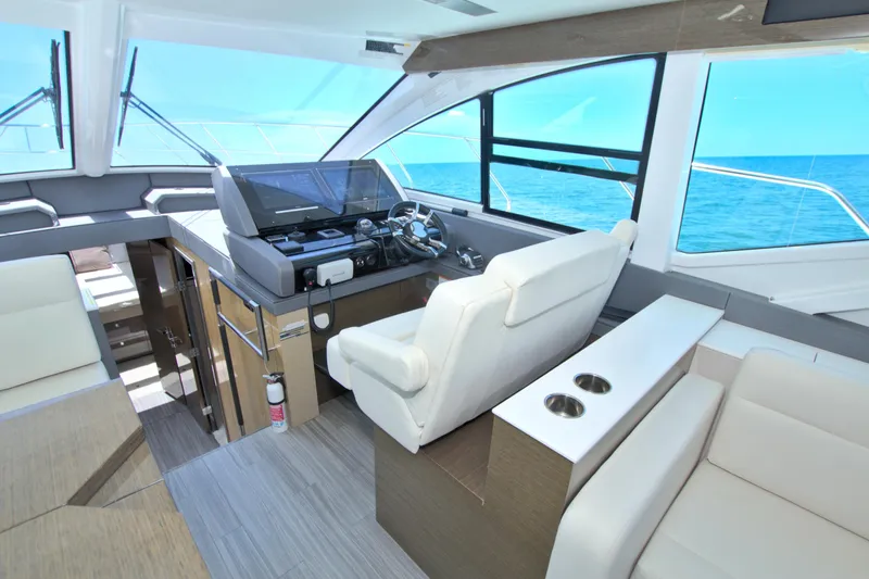 Stepping Stone V Yacht Photos Pics Luxurious interior of 2018 Cruisers Yachts 54 Fly with modern helm and ocean view.