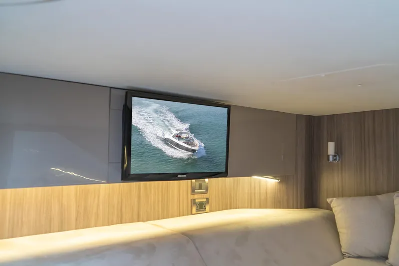  Yacht Photos Pics Interior of 2018 Sea Ray SLX 400 yacht with TV displaying boat on water.