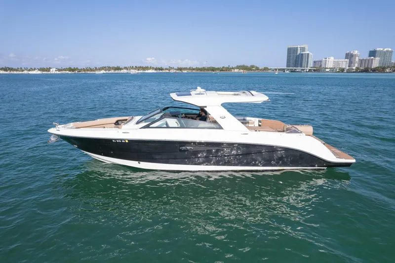  Yacht Photos Pics 2018 Sea Ray SLX 400 boat on calm water with cityscape background.