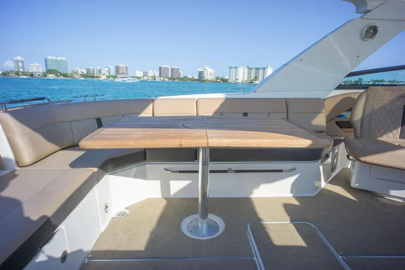  Yacht Photos Pics 2018 Sea Ray SLX 400 yacht interior with elegant seating and table, overlooking a coastal cityscape.