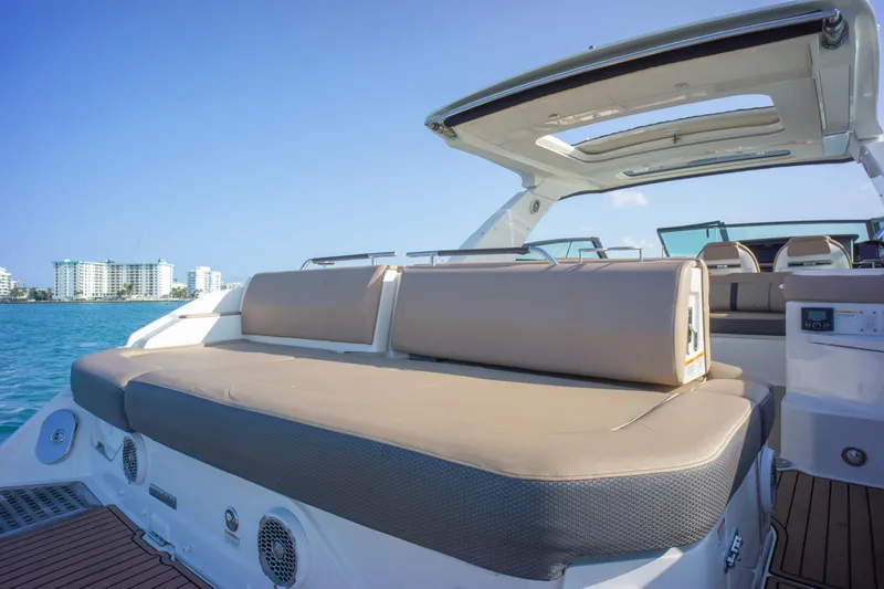  Yacht Photos Pics 2018 Sea Ray SLX 400 luxury boat with spacious seating, docked near waterfront buildings.