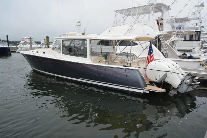 Whim Yacht Photos Pics 2020 MJM 43z yacht docked, featuring sleek design and powerful outboard engines.