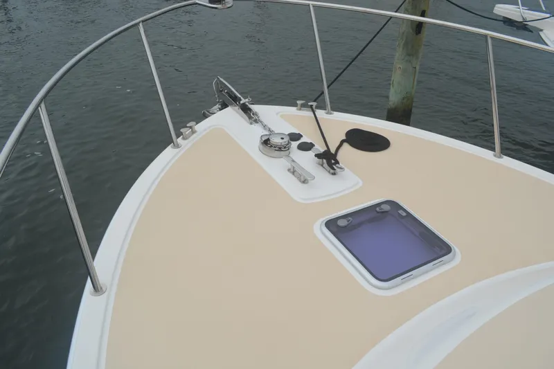 Whim Yacht Photos Pics 2020 MJM 43z boat deck with anchor and hatch, docked on calm water.