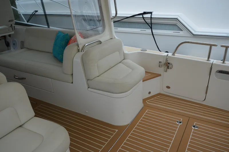 Whim Yacht Photos Pics Interior of 2020 MJM 43z boat with cushioned seating and teak flooring.