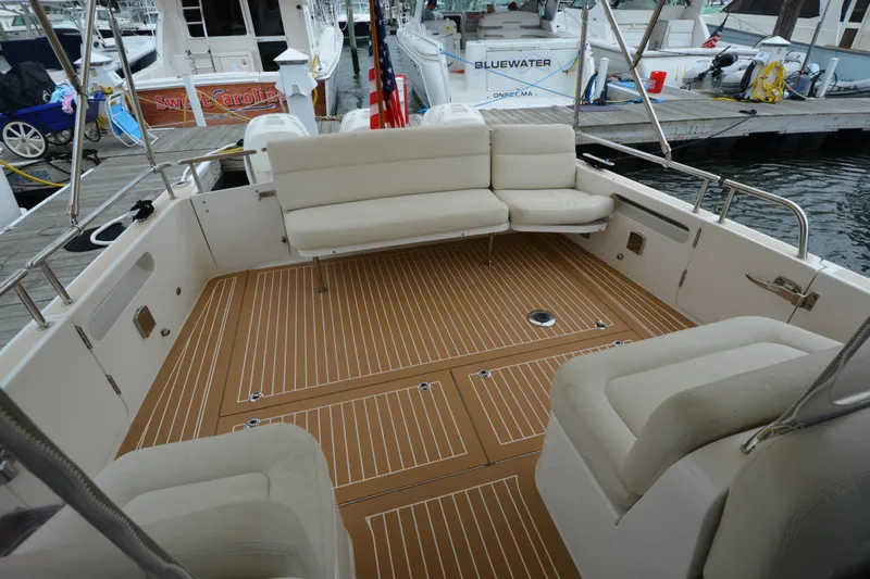 Whim Yacht Photos Pics 2020 MJM 43z boat interior with cushioned seating and teak flooring at a marina.
