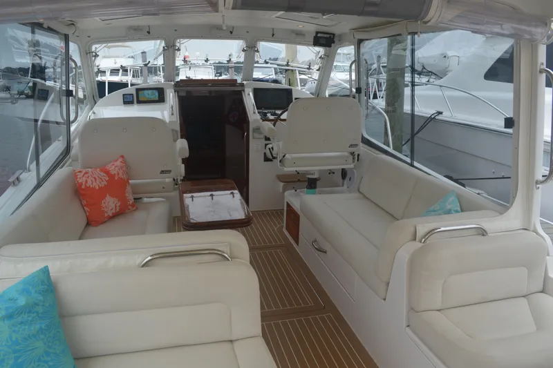 Whim Yacht Photos Pics Interior of 2020 MJM 43z yacht with white seating and colorful cushions.