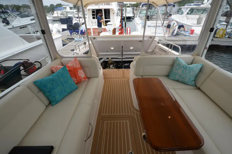 Whim Yacht Photos Pics Luxurious interior of 2020 MJM 43z yacht with elegant seating and vibrant cushions.