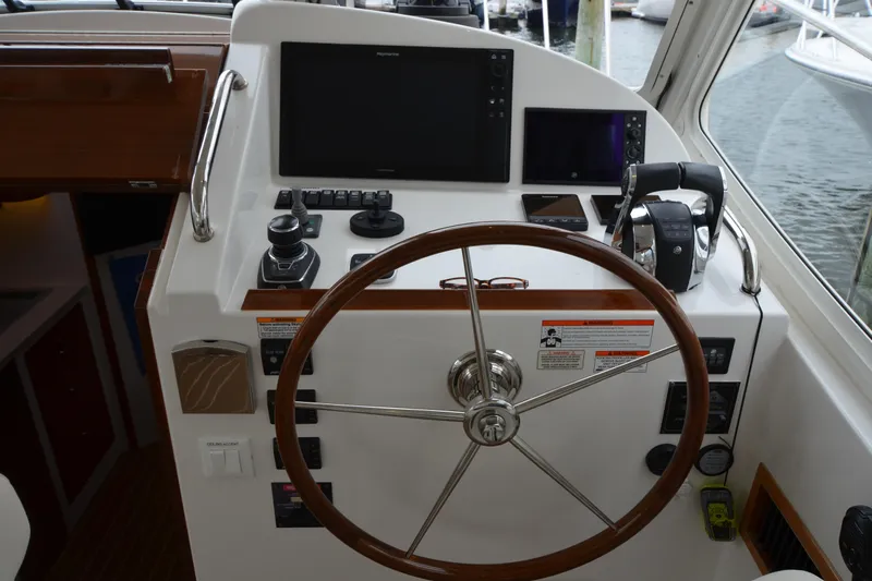 Whim Yacht Photos Pics Helm of 2020 MJM 43z yacht with steering wheel and navigation controls.