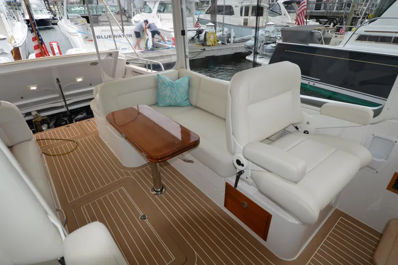 Whim Yacht Photos Pics Luxurious 2020 MJM 43z yacht interior with plush seating and elegant wooden table.