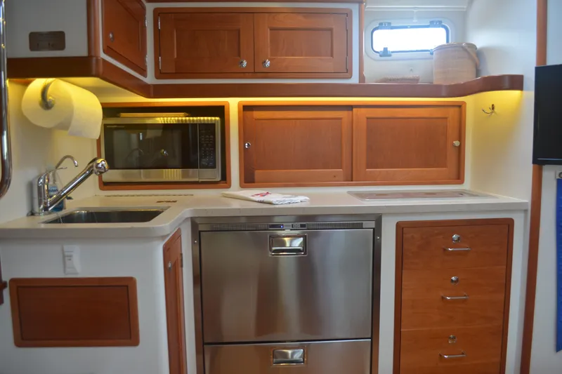 Whim Yacht Photos Pics Modern kitchen in 2020 MJM 43z yacht with wood cabinets and stainless steel appliances.