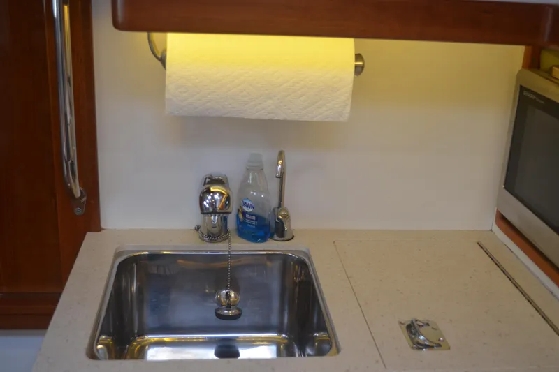 Whim Yacht Photos Pics Compact kitchen sink area in 2020 MJM 43z boat with paper towel holder.