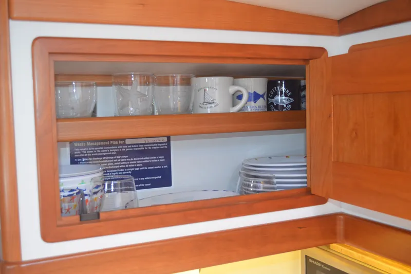 Whim Yacht Photos Pics Wooden cabinet with glassware and mugs inside MJM 43z yacht, 2020 model.