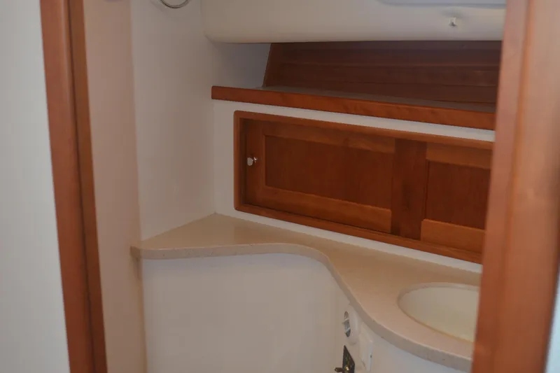 Whim Yacht Photos Pics Interior of 2020 MJM 43z yacht featuring wooden cabinetry and a compact sink area.