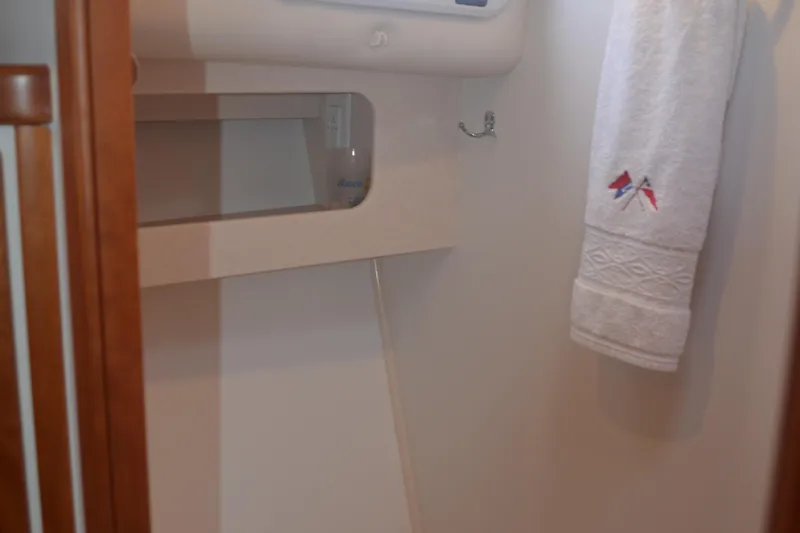 Whim Yacht Photos Pics Interior of 2020 MJM 43z yacht bathroom with towel and storage shelf.