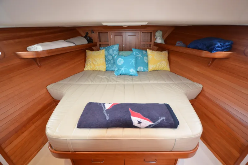 Whim Yacht Photos Pics Cozy cabin interior of 2020 MJM 43z yacht with plush bedding and wooden accents.