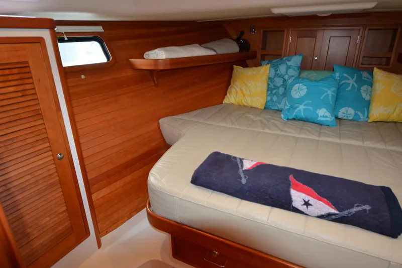 Whim Yacht Photos Pics Cozy cabin interior of 2020 MJM 43z with colorful pillows and wooden accents.