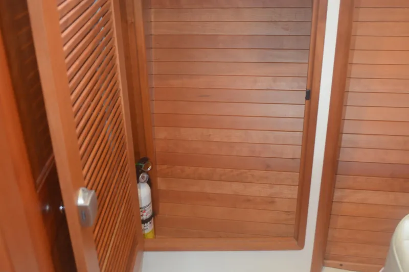 Whim Yacht Photos Pics Wooden interior of 2020 MJM 43z boat with fire extinguisher storage.