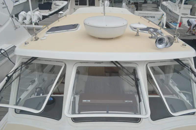 Whim Yacht Photos Pics 2020 MJM 43z yacht with beige deck and windshield, docked at marina.