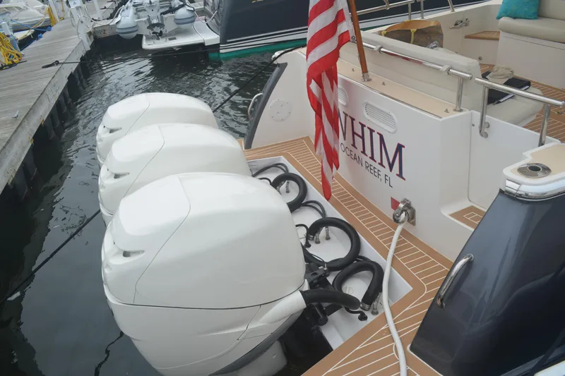 Whim Yacht Photos Pics 2020 MJM 43z boat with triple outboard engines docked at marina.