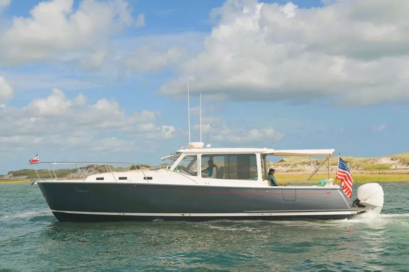 Whim Yacht Photos Pics 2020 MJM 43z boat cruising on water under a partly cloudy sky.