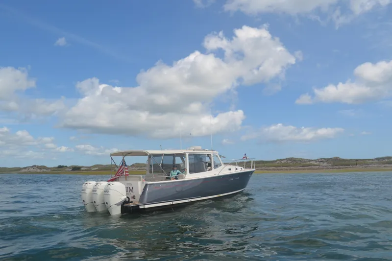 Whim Yacht Photos Pics 2020 MJM 43z boat cruising on water under a clear blue sky.