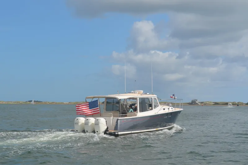 Whim Yacht Photos Pics 2020 MJM 43z boat cruising on open water with American flag.