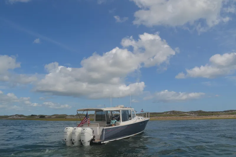Whim Yacht Photos Pics 2020 MJM 43z boat cruising on open water under a clear blue sky.