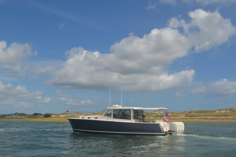 Whim Yacht Photos Pics 2020 MJM 43z boat cruising on a sunny day with blue skies and clouds.