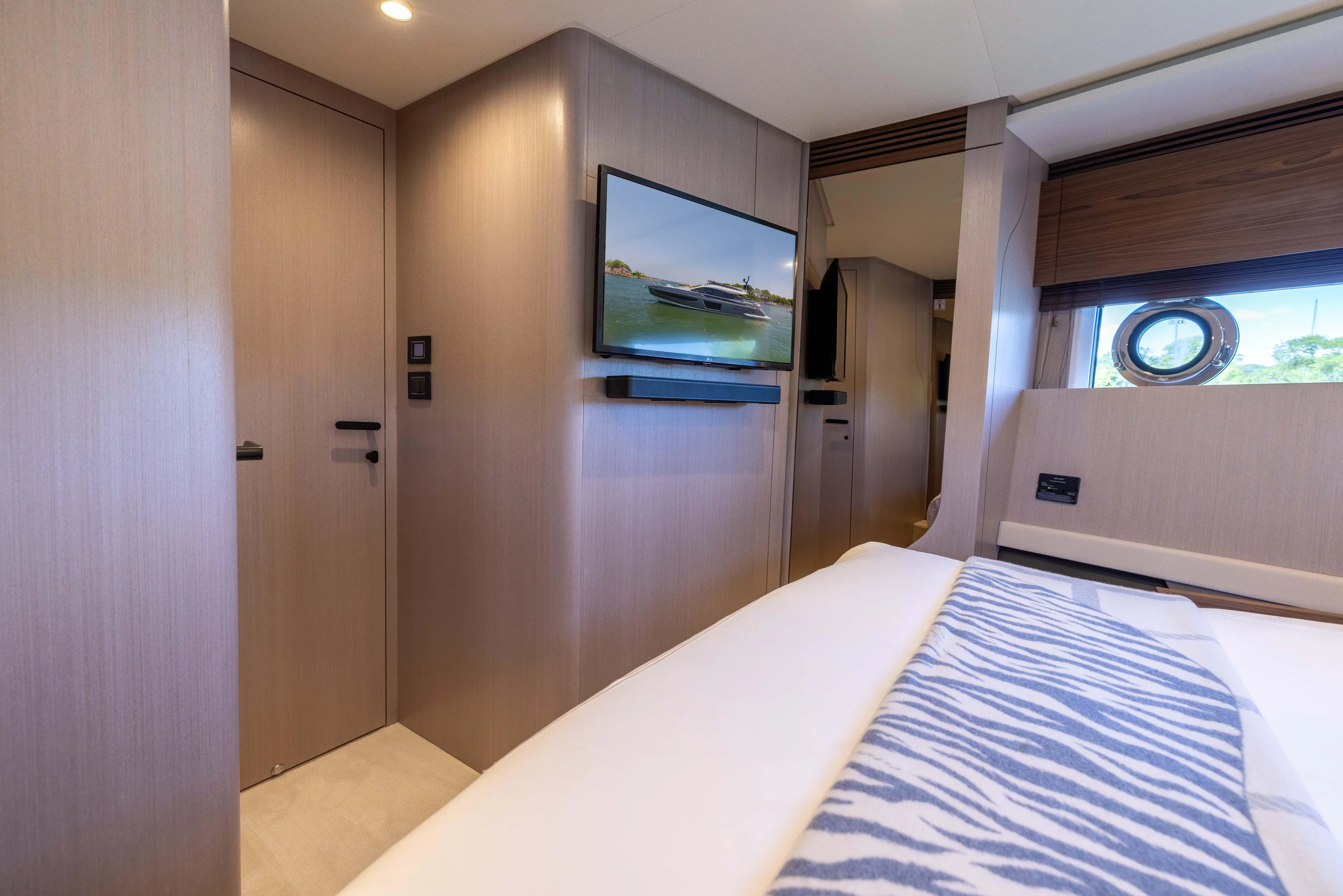 Second Chances Yacht Photos Pics Luxurious interior of 2024 Azimut S7 yacht with modern decor and porthole window.