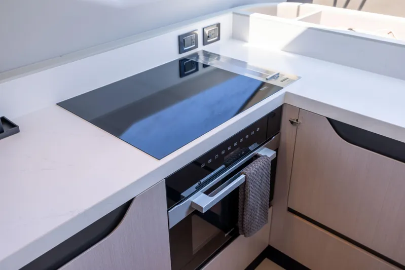 Second Chances Yacht Photos Pics Modern kitchen in 2024 Azimut S7 yacht with sleek induction cooktop.