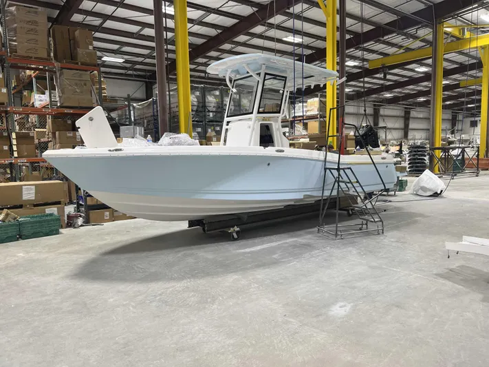 Hybrid Performance Yacht Photos Pics 2025 Caymas 24 HB boat in a warehouse, showcasing sleek design and modern features.