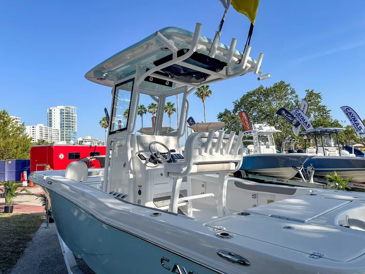 Hybrid Performance Yacht Photos Pics 2025 Caymas 24 HB boat displayed outdoors with cityscape and palm trees in background.