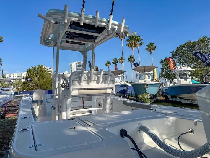 Hybrid Performance Yacht Photos Pics 2025 Caymas 24 HB boat with T-top, displayed outdoors under clear blue sky.