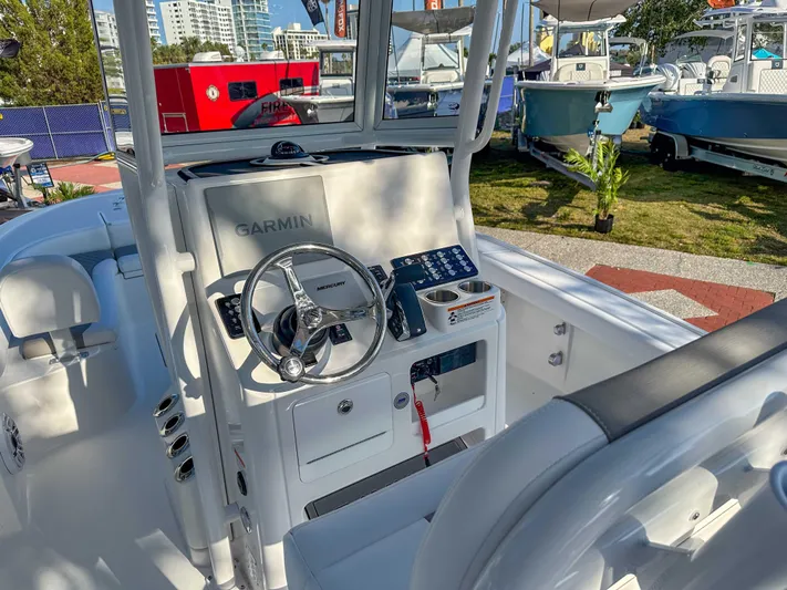 Hybrid Performance Yacht Photos Pics 2025 Caymas 24 HB boat cockpit with Garmin navigation system and steering wheel.